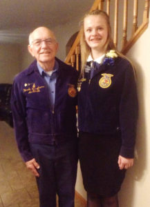 Christina stands with her Grandfather, "Papa Fred," both wearing the blue jackets.